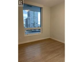 Vancouver apartment for rent - A room with a window overlooking a cityscape.