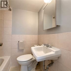 London apartment for rent - A white toilet sits next to a sink in a bathroom.