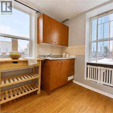 London apartment for rent - A kitchen with wooden cabinets and a white radiator.