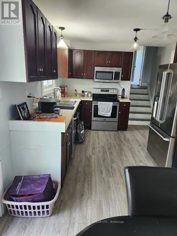Barrie (Allandale) apartment for rent - A kitchen with a white counter top and a purple laundry basket.