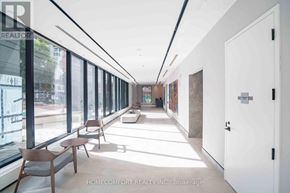 Toronto (North St. James Town) condo for rent - A long hallway with chairs and doors on either side.