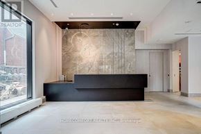 Toronto (North St. James Town) condo for rent - A reception area with a black counter and a large window.