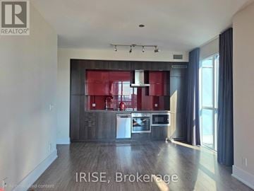 Toronto (Waterfront Communities) condo for rent - A modern kitchen with a red backsplash and stainless steel appliances.
