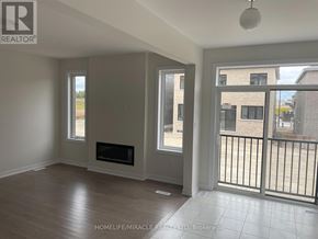 Oshawa (Kedron) apartment for rent - A room with a fireplace and sliding glass doors.