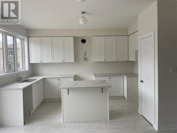 Oshawa (Kedron) apartment for rent - A white kitchen with a sink and cabinets.