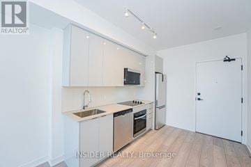 Vaughan (Concord) condo for rent - A modern kitchen with white cabinets and stainless steel appliances.