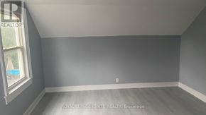 Whitchurch-Stouffville (Stouffville) apartment for rent - A room with a window and a grey wall.