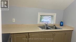 Whitchurch-Stouffville (Stouffville) apartment for rent - A kitchen with a sink and a window.