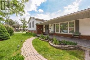 Brampton (Central Park) apartment for rent - A house with a red door and a brick walkway in front.
