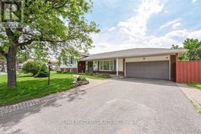Brampton (Central Park) apartment for rent - A house with a red garage door is for sale.