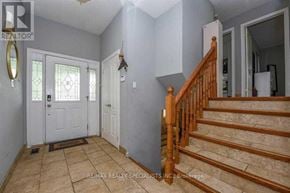 Brampton (Central Park) apartment for rent - A hallway with a staircase and a door with a glass window.