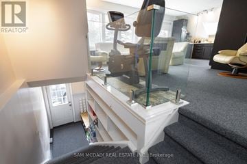 Halton Hills (Rural Halton Hills) duplex for rent - A living room with a glass table and a white couch.