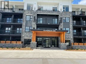 Kitchener condo for rent - The front of a building with the sign 110 Fergus Ave.
