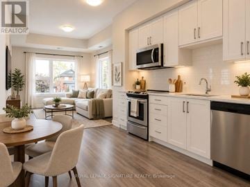 Kitchener condo for rent - A hallway with a wooden floor leads to a kitchen.