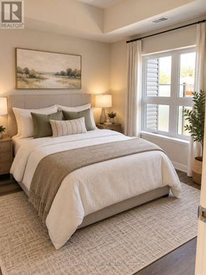 Kitchener condo for rent - A bedroom with a large bed and a painting on the wall.