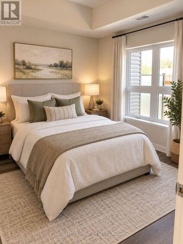 Kitchener condo for rent - A bedroom with a large bed and a painting on the wall.