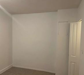 Surrey apartment for rent - A white wall with a door on the right side.