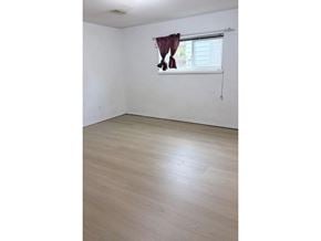 Surrey apartment for rent - A room with a window and a curtain.