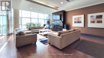 Markham (Unionville) condo for rent - A living room with a large couch and a television.