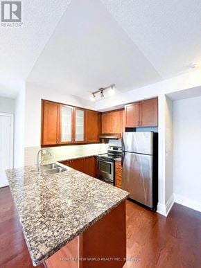 Markham (Unionville) condo for rent - A kitchen with granite countertops and wooden cabinets.