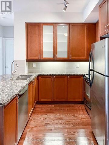 Markham (Unionville) condo for rent - A kitchen with wooden cabinets and a granite counter top.