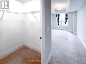 Markham (Unionville) condo for rent - A room with a white wall and a door leading to another room.