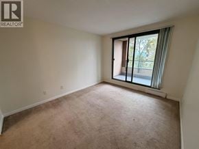 Burnaby apartment for rent - A room with a window and a carpeted floor.