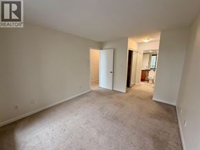 Burnaby apartment for rent - A large, empty room with a doorway leading to another room.