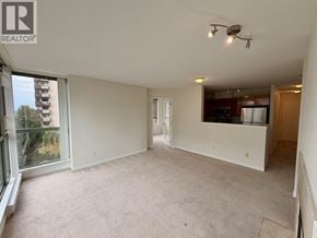 Burnaby apartment for rent - A spacious room with a carpeted floor and a ceiling fan.