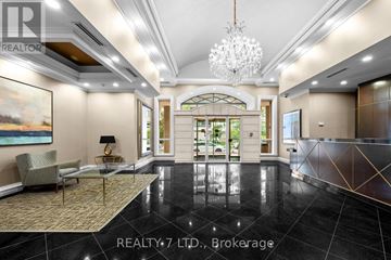Toronto (Don Valley Village) condo for rent - A luxurious living room with a chandelier, a sofa, a chair, and a painting on the wall.