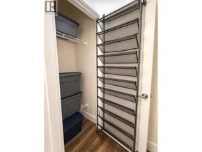 Coquitlam apartment for rent - A small, narrow closet with a sliding door and a bench inside.