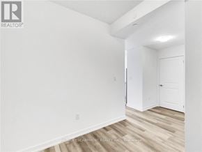 Hamilton (Waterdown) condo for rent - A white room with a door and a window.