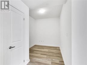 Hamilton (Waterdown) condo for rent - A white door is on the left of a room with wooden flooring.