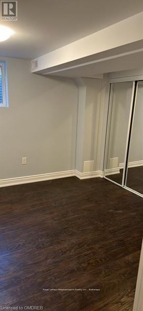 Milton (Ha Harrison) apartment for rent - A room with wooden flooring and white walls.