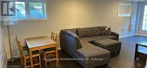 Milton (Ha Harrison) apartment for rent - A living room with a grey couch and a wooden table.