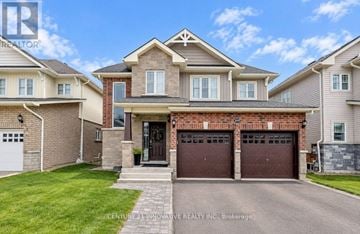 Orillia apartment for rent - A large, well-maintained house with a brick facade and a large front yard.