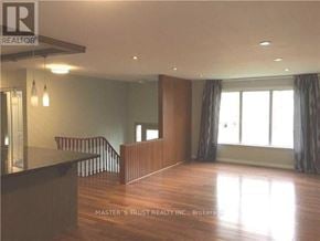 Richmond Hill (North Richvale) apartment for rent - A spacious room with wooden floors and a large window.