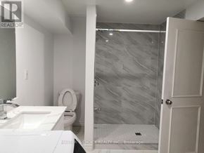 Vaughan (Glen Shields) apartment for rent - A bathroom with a toilet, sink, and shower.