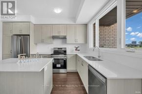 Oakville (Jm Joshua Meadows) townhouse for rent - A modern kitchen with white cabinets and appliances.