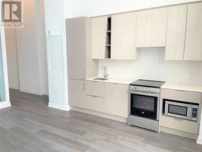 Mississauga (City Centre) condo for rent - A kitchen with a stove top oven and microwave.