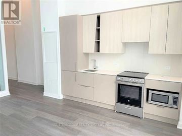 Mississauga (City Centre) condo for rent - A kitchen with a stove top oven and microwave.