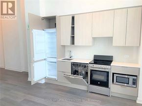 Mississauga (City Centre) condo for rent - A kitchen with a refrigerator, oven, and microwave.