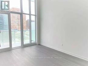 Mississauga (City Centre) condo for rent - A room with a view of a cityscape through large windows.