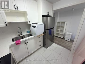 Markham (Wismer) apartment for rent - A kitchen with white cabinets and a stainless steel refrigerator.