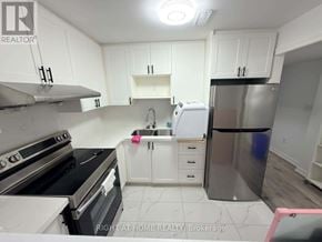 Markham (Wismer) apartment for rent - A kitchen with white cabinets and a stainless steel refrigerator.