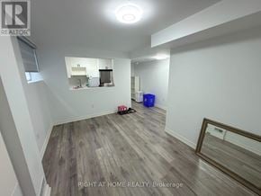 Markham (Wismer) apartment for rent - A room with a wooden floor and a mirror on the wall.