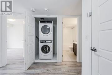 Toronto (Downsview-Roding-Cfb) townhouse for rent - A white washing machine is in a small alcove in a home.