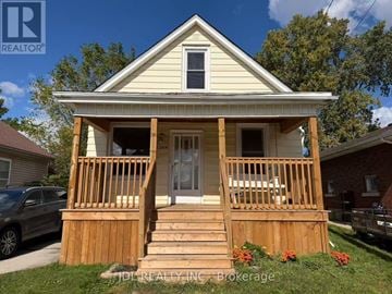 Niagara Falls (Dorchester) apartment for rent - A house with a porch and a car parked in front.