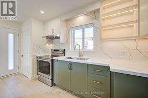 Toronto (Dorset Park) apartment for rent - A kitchen with green cabinets and a marble countertop.