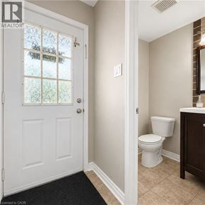London apartment for rent - A white door with a glass window is in a room with a toilet and a cabinet.
